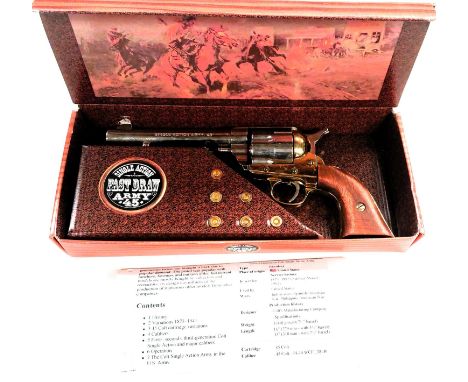 A boxed single action fast draw army Colt 45, silver and gilt with wooden grip. 