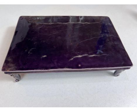 An unusual Chinese ceramic table stand of rectangular form with 4 legs shaped of beasts with long tongues, purple in colour, 