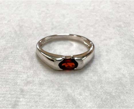 A 9ct hallmarked white gold dress ring set with oval Ruby coloured, size N, weight 2.1gm 