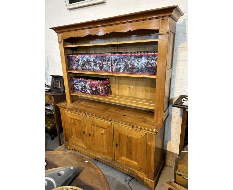 A large light wood satin finish traditional style farm kitchen style dresser with three hight shelves above and three cupboar