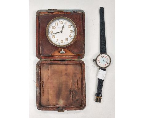 An early wristwatch with colour enamelled dial, case stamped OMEGA, a Swiss travelling clock 