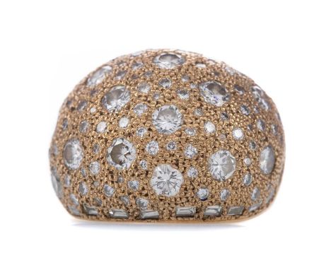 DIAMOND BOMBE RING BY ERIC SMITH OF GLASGOW,set with round brilliant cut diamond bordered by baguette cut diamonds totalling 