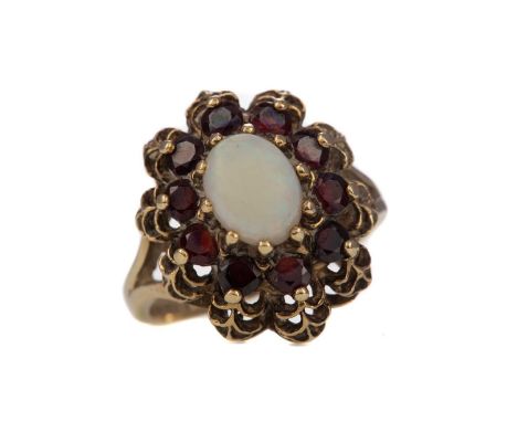 OPAL AND GARNET RING,set with an oval opal within a garnet halo, in nine carat gold, size K 1/2, 4.8gCondition report: In wor