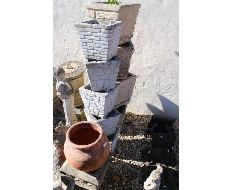 Group of reconstituted stone planter pots to include a rose emblem pair, brick effect examples and a round terracotta pot (11