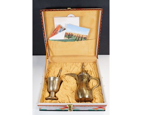 Saudi Arabian presentational brass Dallah coffee pot, together with a footed pestle and mortar in presentational box. Box mea