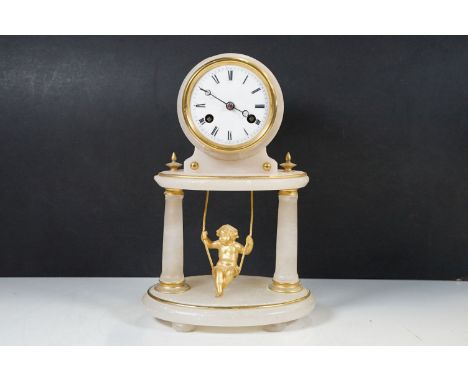 A French onyx and gilt metal mantel clock, with “cherub in a swing” pendulumh: 29cm