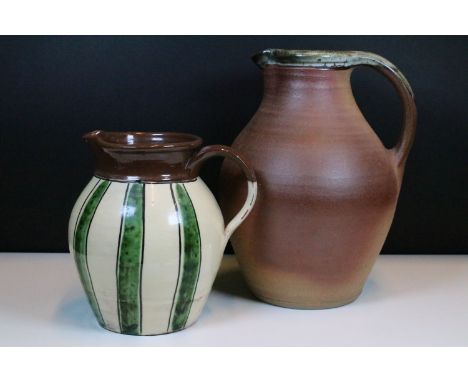 Large Muchelney stoneware pottery pitcher jug with makers mark to base H 31cm together with a striped design pottery pitcher 