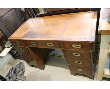 20th century mahogany campaign desk with brown leather inset top above an arrangement of nine drawers raised on bracket feet,