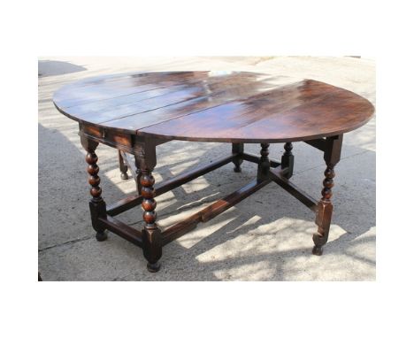 17th Century gateleg table with bobbin turned legs, drop leaves and two end drawers. 79cm high, 162cm wide, 196cm long approx
