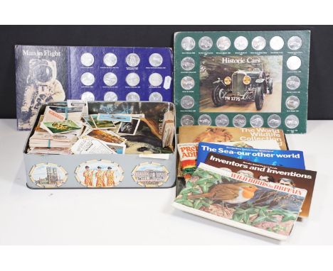 A small collection of cigarette and tea cards both loose and within albums together with a set of man in flight medallions. 