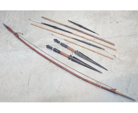 Collection of tribal items including bow, arrows, darts and other items