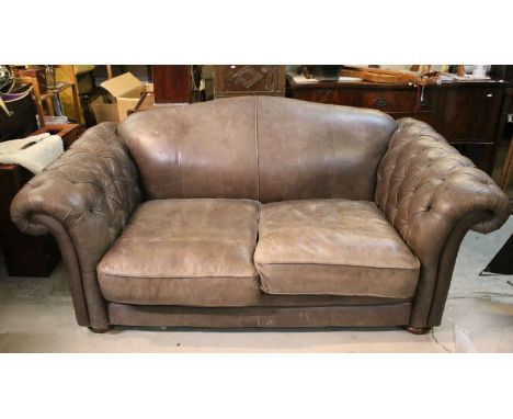 20th century large two seater Chesterfield style leather sofa with button arms raised on bun feet, H 89cm W 200cm, D 113cm