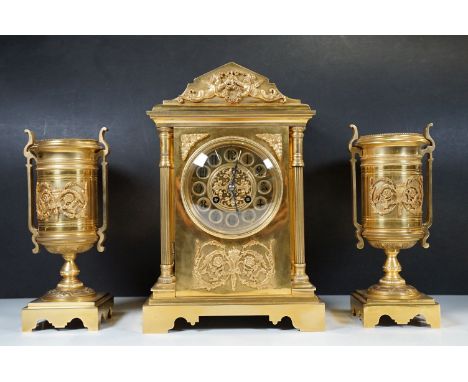 A 19th century French brass clock garniture, the mantel clock of classic architectural form, the movement stamped Japy Fréres