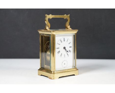 A brass carriage alarm clock, the white dial with an alarm subsidiary, lacking handsh:11cm