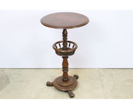 19th century Victorian mahogany lamp table having a round top on central turned column raised on tripod base with scrolled fe