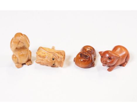 Four wooden miniature netsuke figures to include signed Buddhas head, signed dragon head, signed See No Evil Monkey and signe