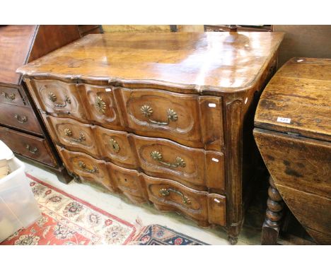 18th century French walnut commode, the shaped serpentine top above three triple panelled drawers on carved feet, 89cm high x