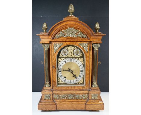 An oak mantel clock, the 18.5cm arched dial signed by the retailer Charles Fox of Bournemouth and Yeovilh: 60cm