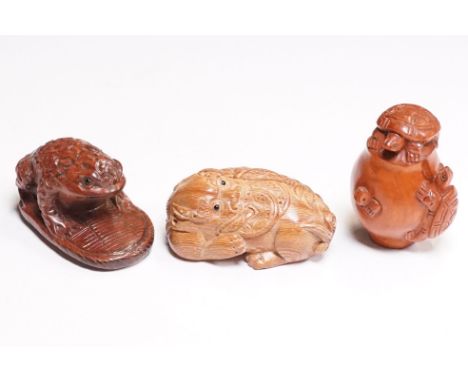 Three wood netsuke figures to include signed turtles on pot, signed money dragon and toad