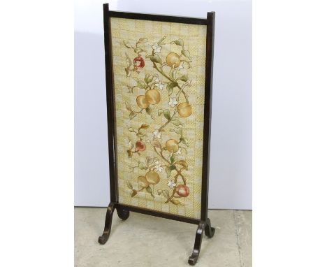 Early 20th Century fire screen of rectangular form with embroidered central panel featuring fruits, raised on splayed legs. M