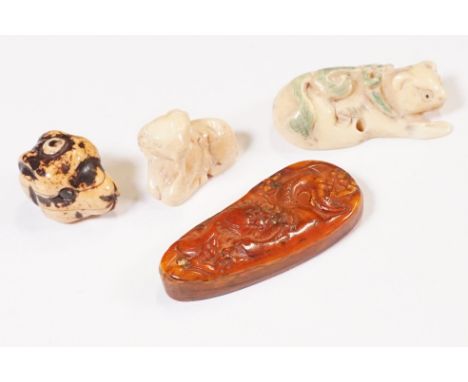 Four miniature bone netsuke figures to include signed dogs head, seated goat, cat, and dragon panel