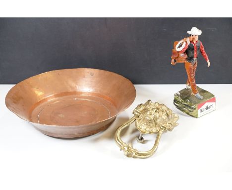 A large brass lion's head door knocker together with a beaten copper bowl, 36cm diameter and a vintage Marlboro filter cigare