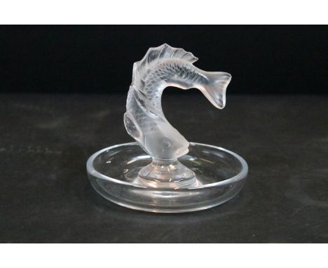 Lalique moulded glass fish pin dish having a round base with curved fish to centre. Signature to base. Measures 10cm wide. 