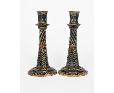 A pair of Martin Brothers stoneware candlesticks by Robert Wallace Martin, tapering cylindrical form, incised with alternatin