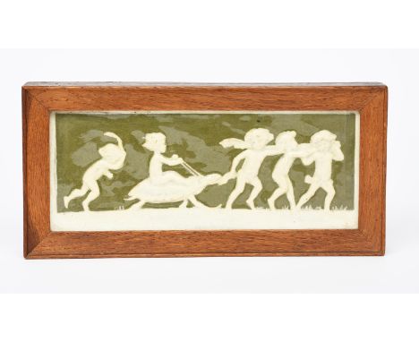 A Della Robbia pottery plaque designed by Ellen Mary Rope, modelled in low relief with a child riding a tortoise, glazed in w