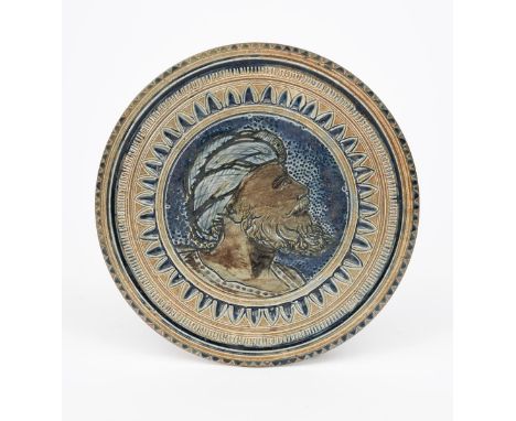 An early Martin Brothers stoneware stand by Robert Wallace Martin, dated 1876, circular, incised to the centre with a portrai