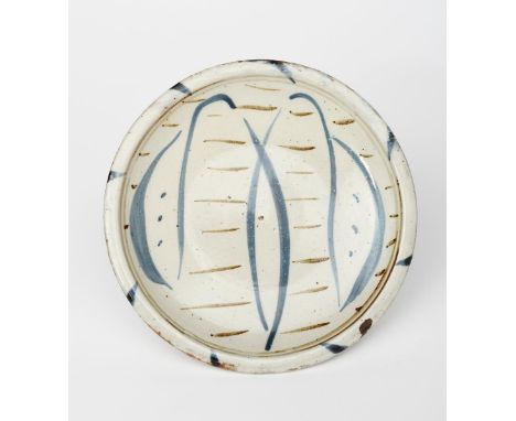 Michael Cardew CBE (1901-1983) a Wenford Bridge plate, painted with a simple foliate motif in blue on a speckled pale celadon