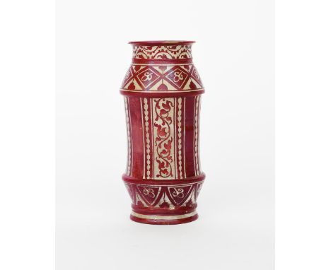 A stoneware albarello vase,  shouldered, cylindrical form with raised bands, painted with columns of scrolling foliage and be