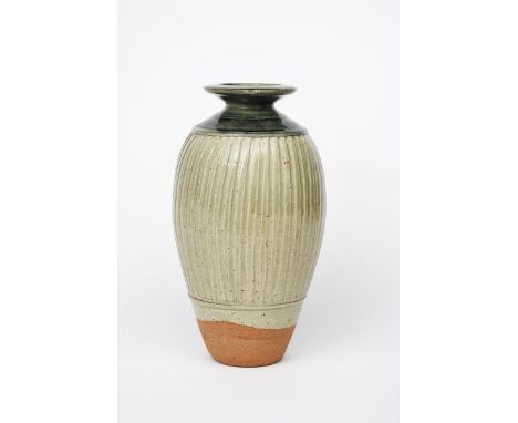 ‡ Richard Batterham (born 1936) a tall stoneware vase, shouldered form with flaring rim, the body with a broad band of flutin