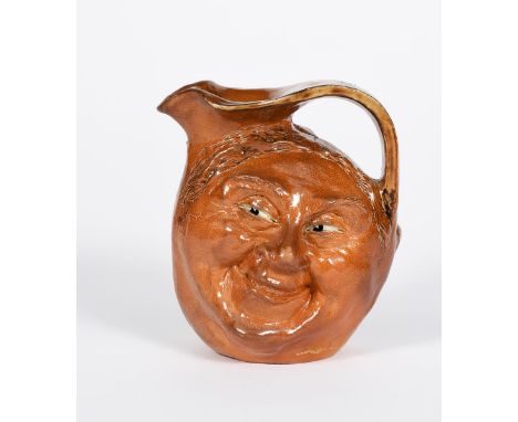 A Martin Brothers stoneware face jug by Robert Wallace Martin, dated 1905,  modelled to one side with a smiling face, the rev