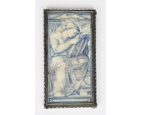 A Pre-Raphaelite tile plaque probably Copeland, painted with a classical maiden, seated and reading from a large book, in sha