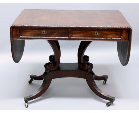 GEORGE IV MAHOGANY SOFA TABLE, the rounded rectangular top with egg and dart moulding, opposing true and false drawers, scrol