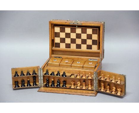 VICTORIAN OAK AND BRASS BOUND GAMES COMPENDIUM, the cover enclosing a fitted interior with chequers board, chess pieces, play
