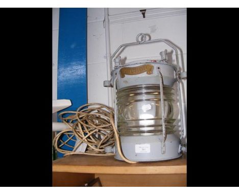 A hanging ships anchor light in grey metal case