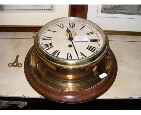An old brass cased ship's bulkhead clock with separate second hand - 23cm diameter 