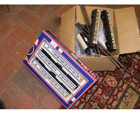 A boxed set of Lima carriages, together with loose rolling stock and track 
