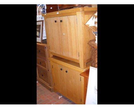 A pair of light oak side cabinets enclosed by a pair of doors - width 90cms