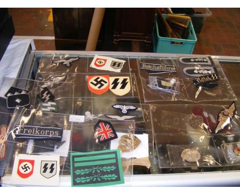 A selection of German World War II badges, epaulettes, etc.  