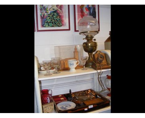 A cranberry glass jug in the style of Mary Gregory, alabaster plaque of castle scene, reproduction oil lamp, model of church 