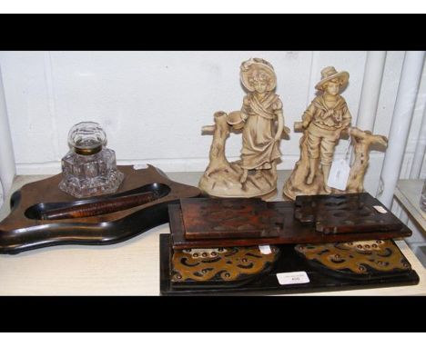 Two Victorian book troughs, a Victorian ink stand, together with two ceramic figures