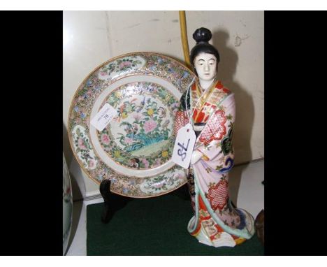 An oriental Famille Verte plate with bird and flower decoration - 20,5cm diameter - together with a ceramic figure of Japanes
