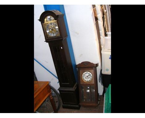 A reproduction Grandmother clock together with a wall clock