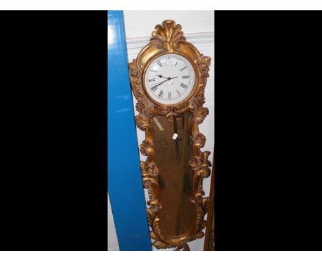 A reproduction French style wall clock with riccoco gilt frame and mirror under 