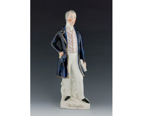 A Staffordshire figure of the Duke of Wellington, circa 1850, modelled standing, wearing a patterned waistcoat and blue coat 