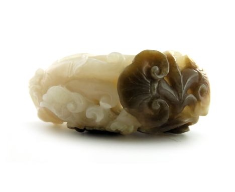 A Chinese pale celadon jade carving of a finger citron and ruyi head, russet brown inclusions, 6.5cm long