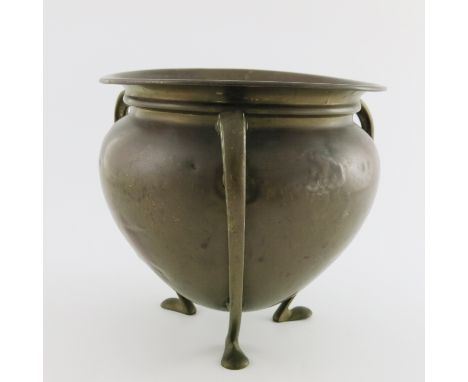 William Soutter &amp; Sons, an Arts &amp; Crafts brass planter, of teardrop form with tendril tripod legs and pad feet, maker
